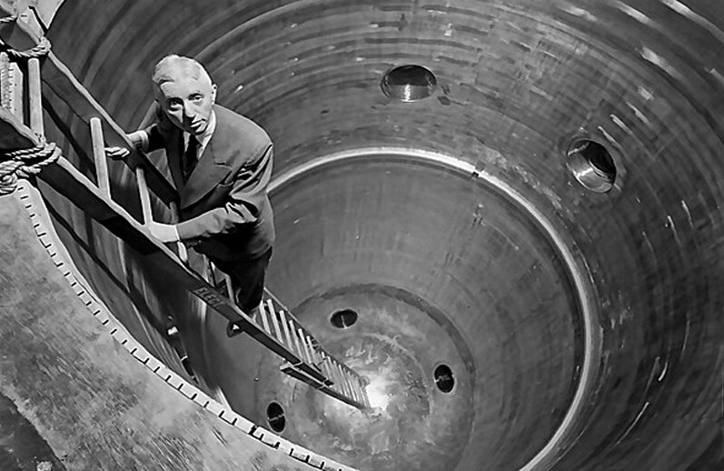 Admiral Rickover descends into the circular nuclear reactor shell at the Shippingport Power Facility. Courtesy of LIFE magazine, via <a href="https://commons.wikimedia.org/wiki/File:Admiral_Rickover_descends_into_the_nuclear_reactor_shell_at_the_Shippingport_Power_Facility_(14492227730).jpg">Wikipedia</a>..