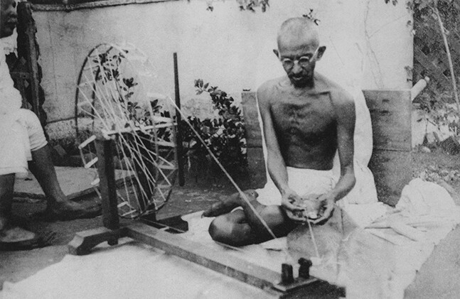 Mahatma Gandhi spinning yarn, in the late 1920s. Public Domain via <a href="http://en.wikipedia.org/wiki/Mahatma_Gandhi#/media/File:Gandhi_spinning.jpg">Wikipedia</a>