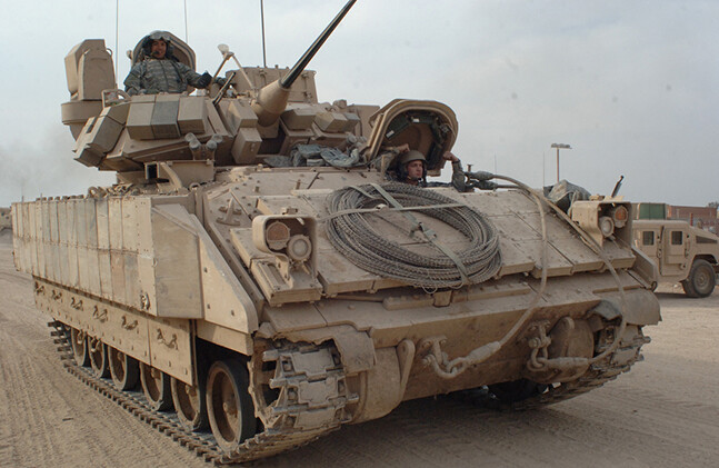 U.S. Army Soldiers drive a Bradley Fighting Vehicle in East Baghdad, Iraq (2007).<br>CREDIT: <a href="https://www.flickr.com/photos/soldiersmediacenter/421323075/">The U.S. Army</a> (<a href="https://creativecommons.org/licenses/by/2.0/">CC</a>)
